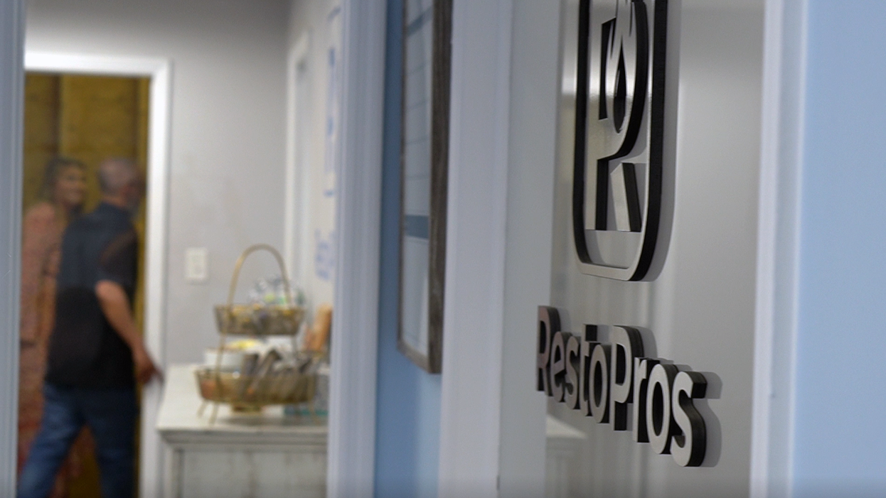 A wall wth the RestoPros logo on it