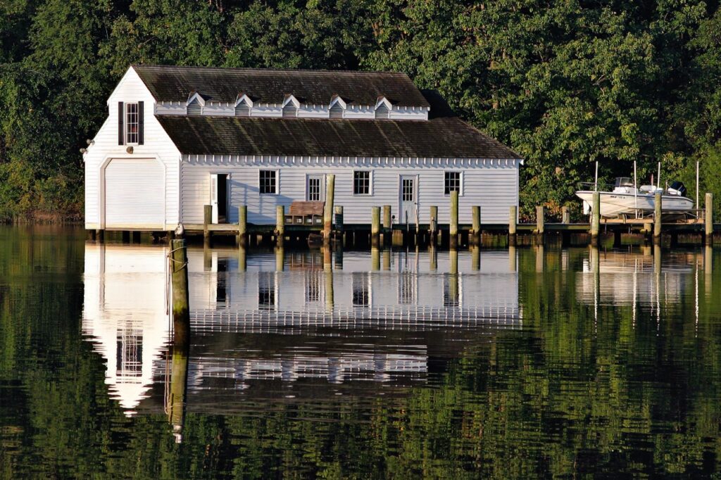Sevena Park, MD USA Sep 23, 2004: A large boathouse casts a reflection on the waters of the Severn River, an estuary leading to the Chesapeake Bay, near Annapolis MD.