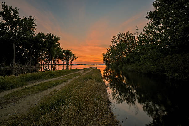 Sunrise colors over Lake Lowell in Idaho with a road that lead into it