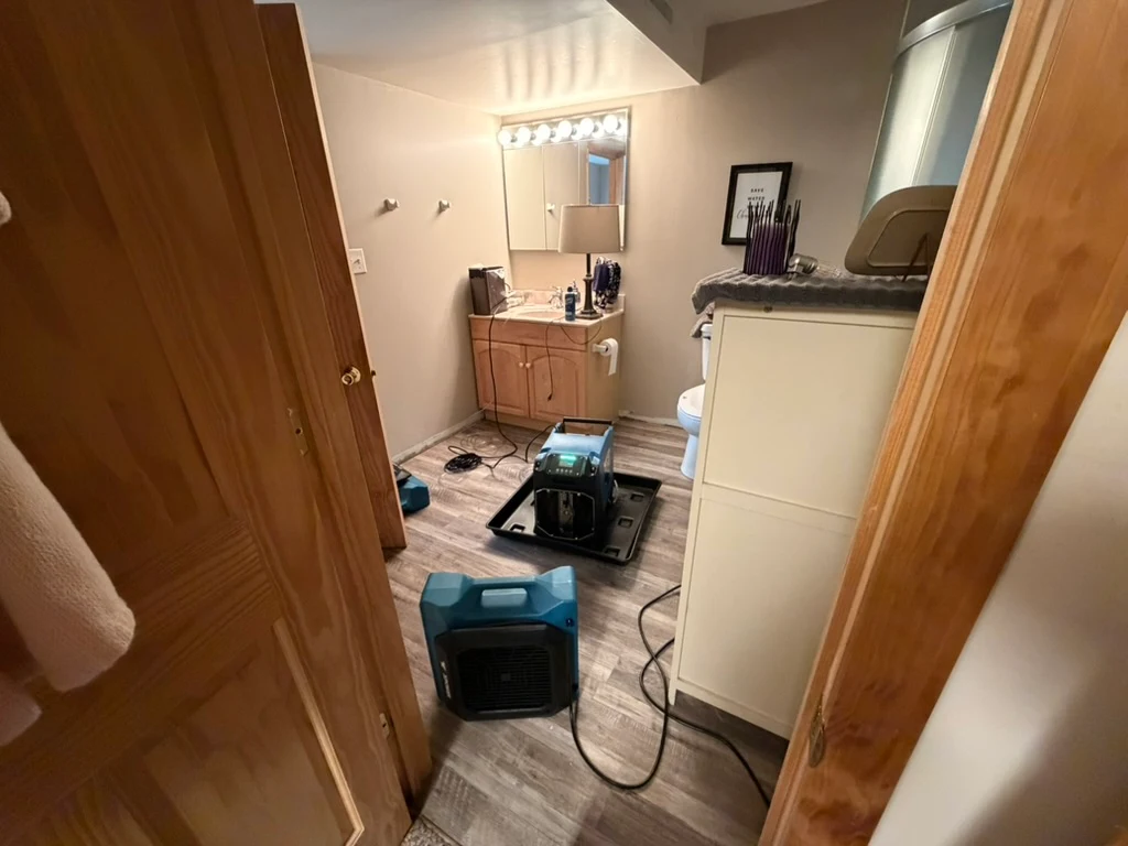 Restopros equipment working on a water damage restoration job in a bathroom.