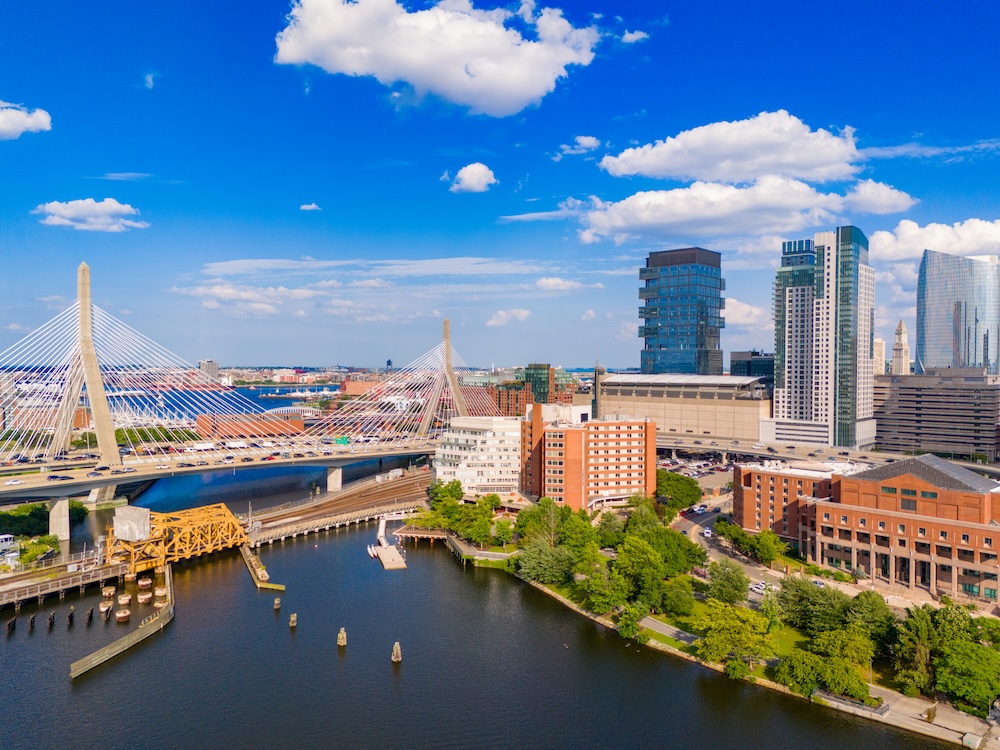 Amazing aerials of Downtown Boston. View of river bridges skyscraper offices and blue sky 2024