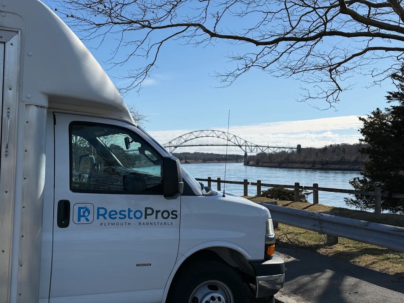 RestoPros truck in front of a bridge