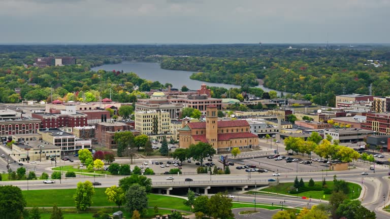 Aerial establishing shot of downtown Saint Cloud, a city in Minnesota, on an overcast day in Fall.