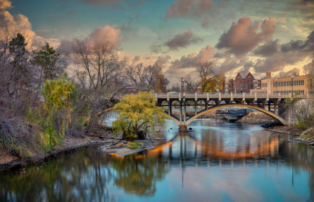 Reflection of bridge at sunset. Rum River in Anoka Minnesota Midwest USA. Horizontal
