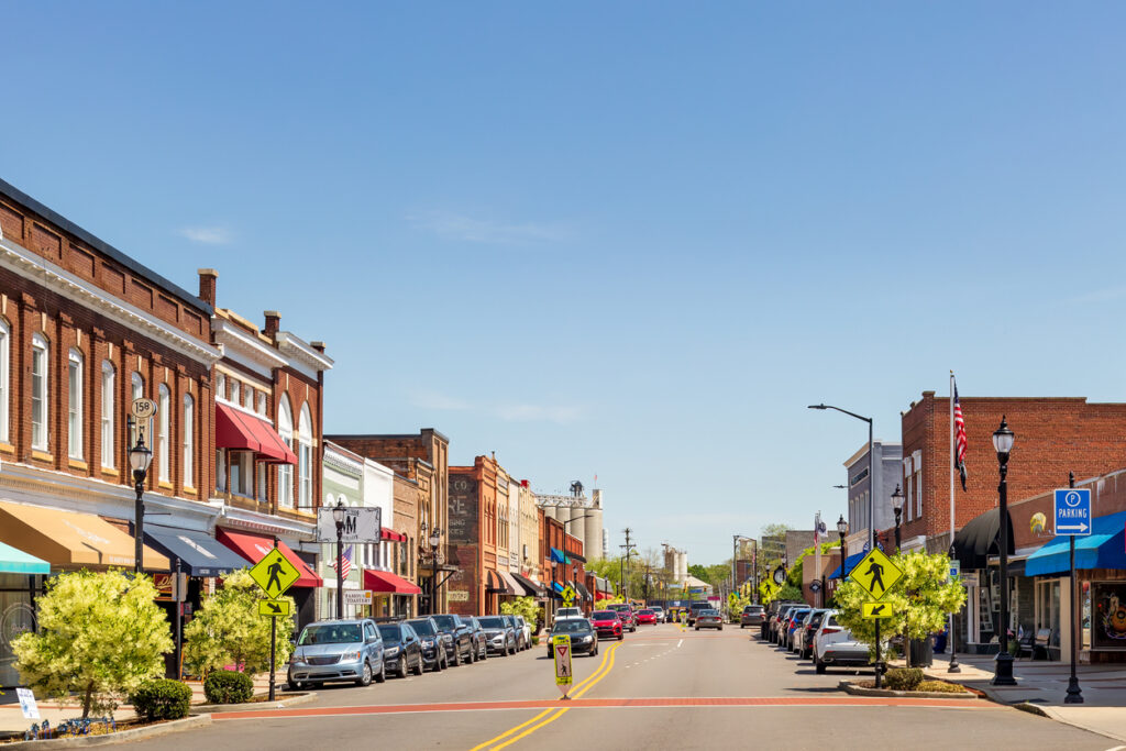 Mooresville, NC, USA-17 April 2022: Iconic, colorful wide-angle Main Street view on a sunny, blue sky, spring day. Looking toward Bay State Milling Co.
