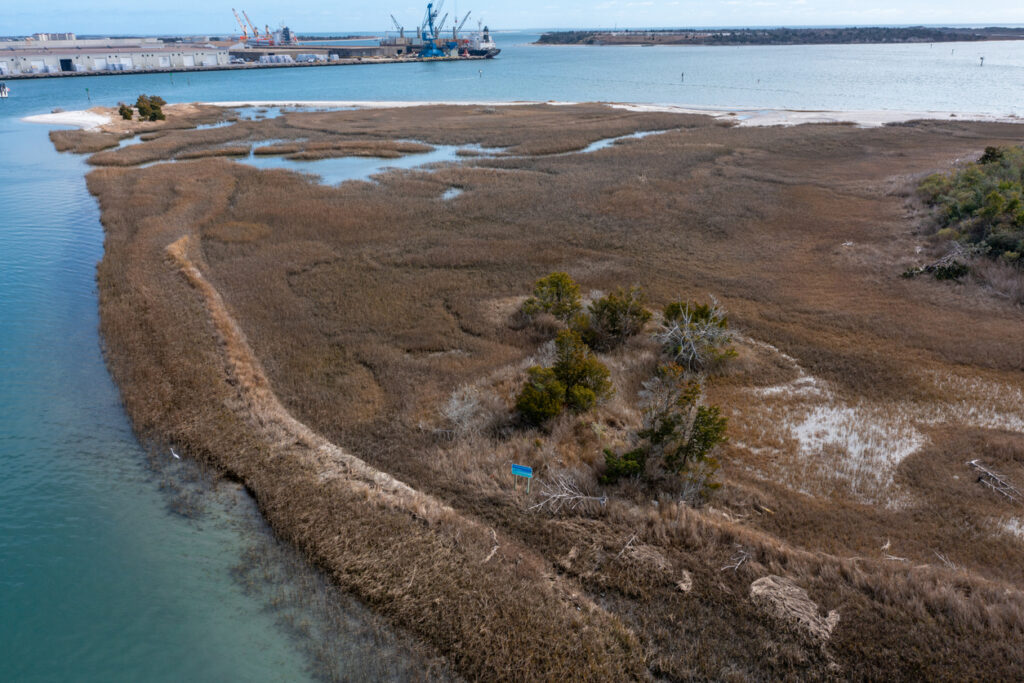 Aerial view of marshy Sugarloaf island in Morehead City looking towards container ships and the port