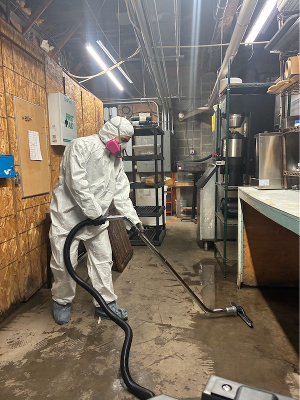 Man using water damage restoration equipment