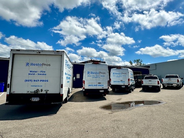RestoPros Dayton restoration trucks and vans parked outside the company facility.