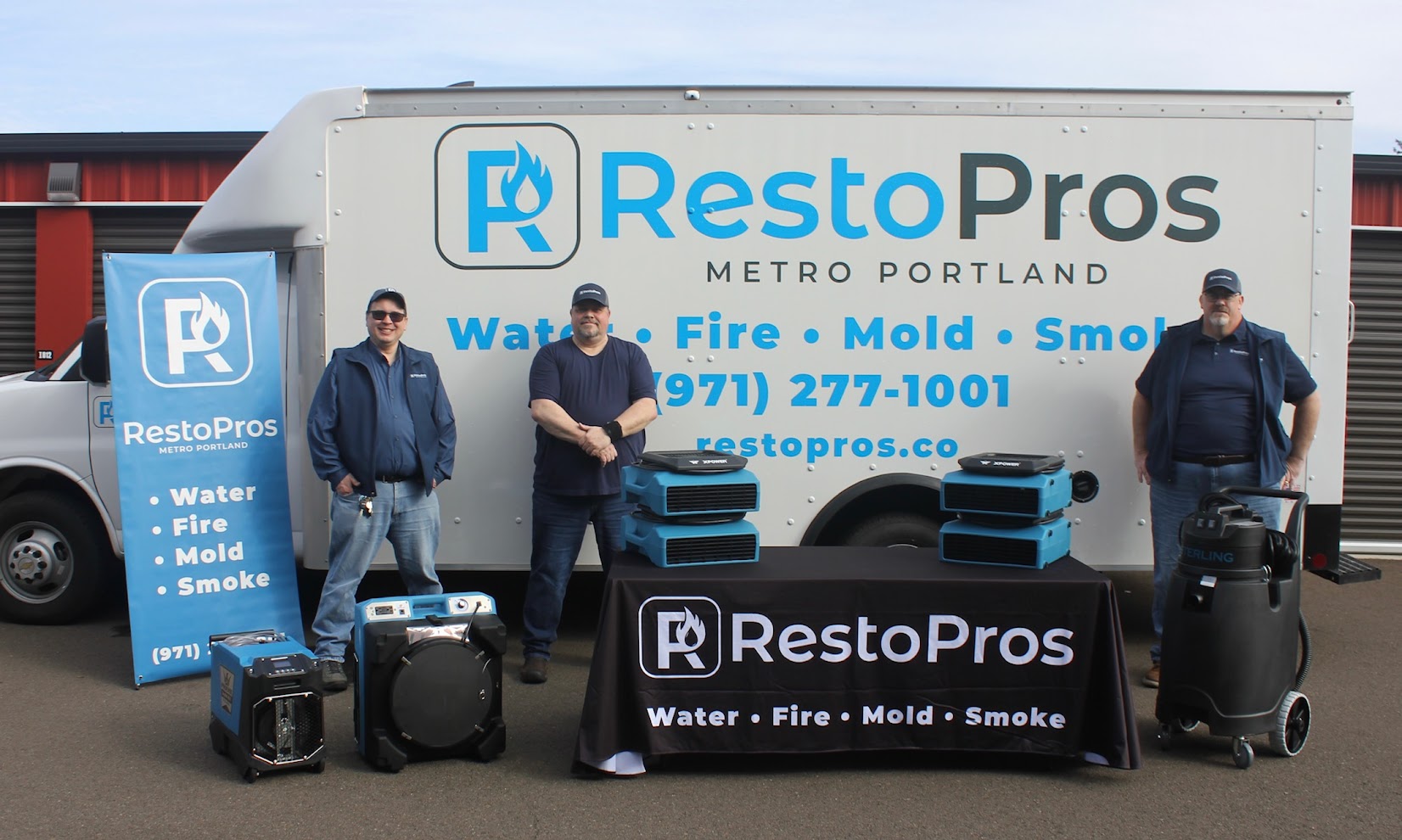 RestoPros team members in front of their truck