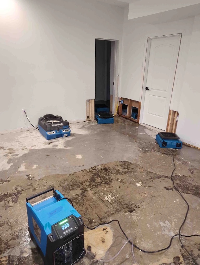 Water damage restoration vaccuum on damaged floor