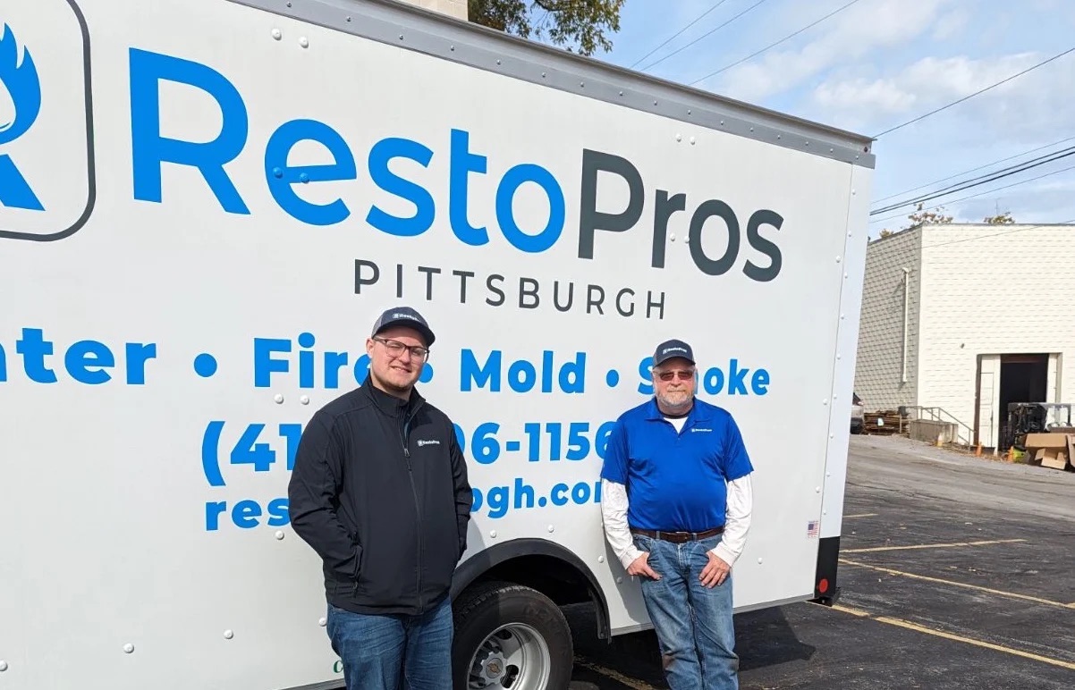 Workers in front of a RestoPros of Pittsburgh truck