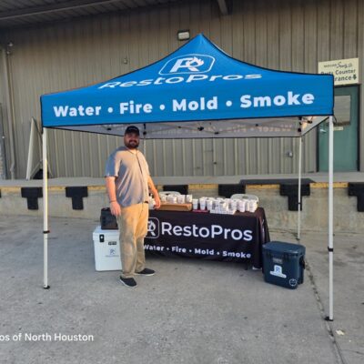 RestoPros owner in front of a RestoPros tent