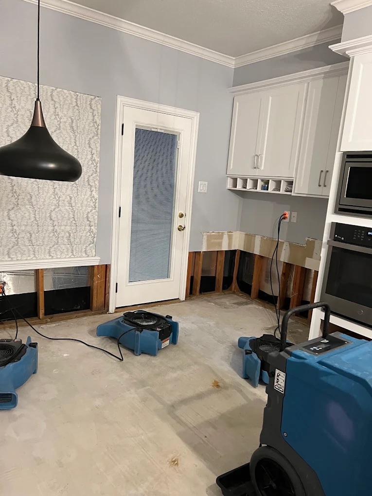 Water damage restoration machines in kitchen