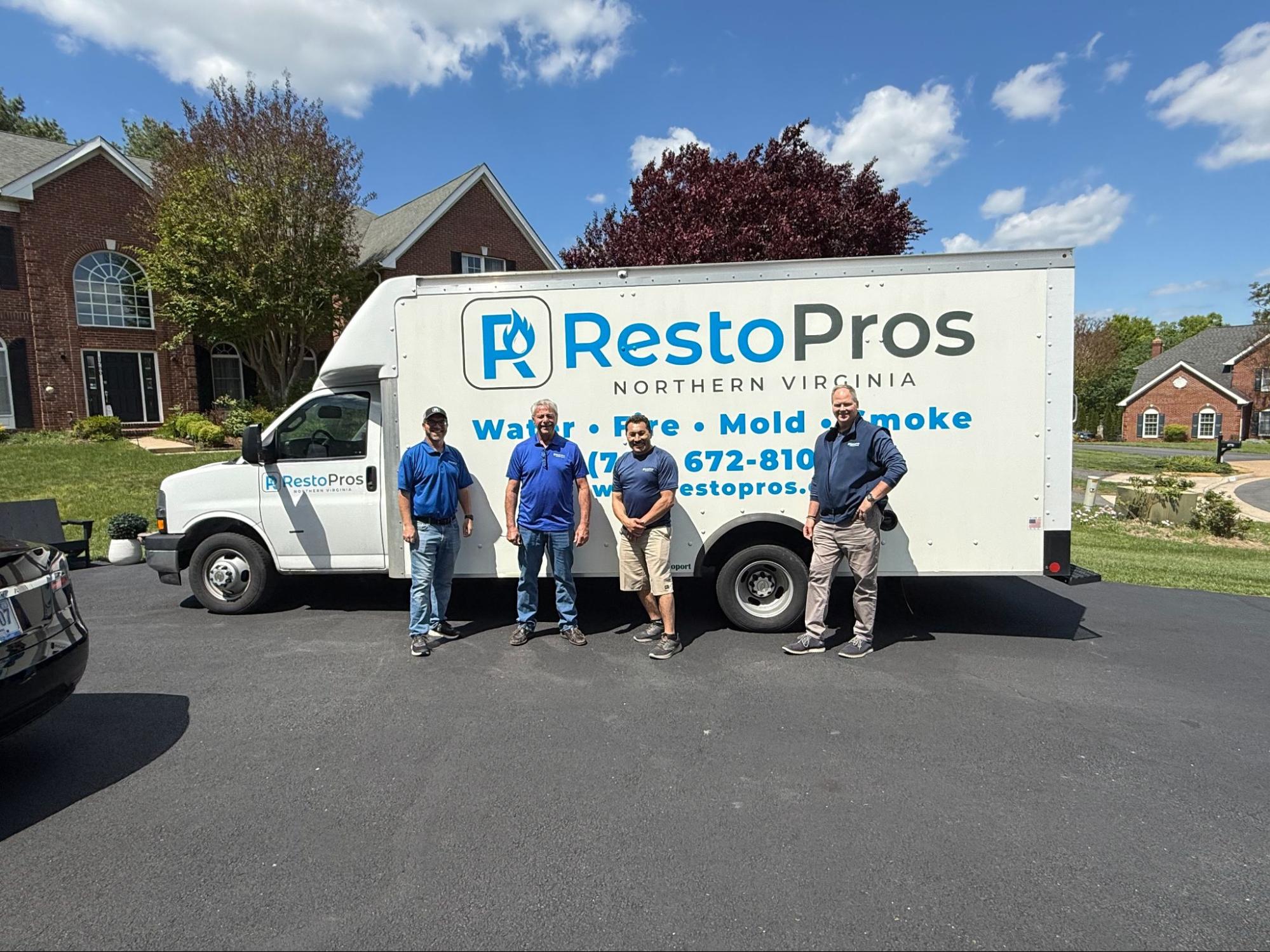 4 men standing in front of a RestoPros Northern Virginia truck