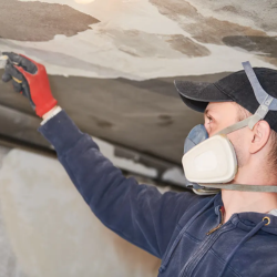 man in mask for mold remediation