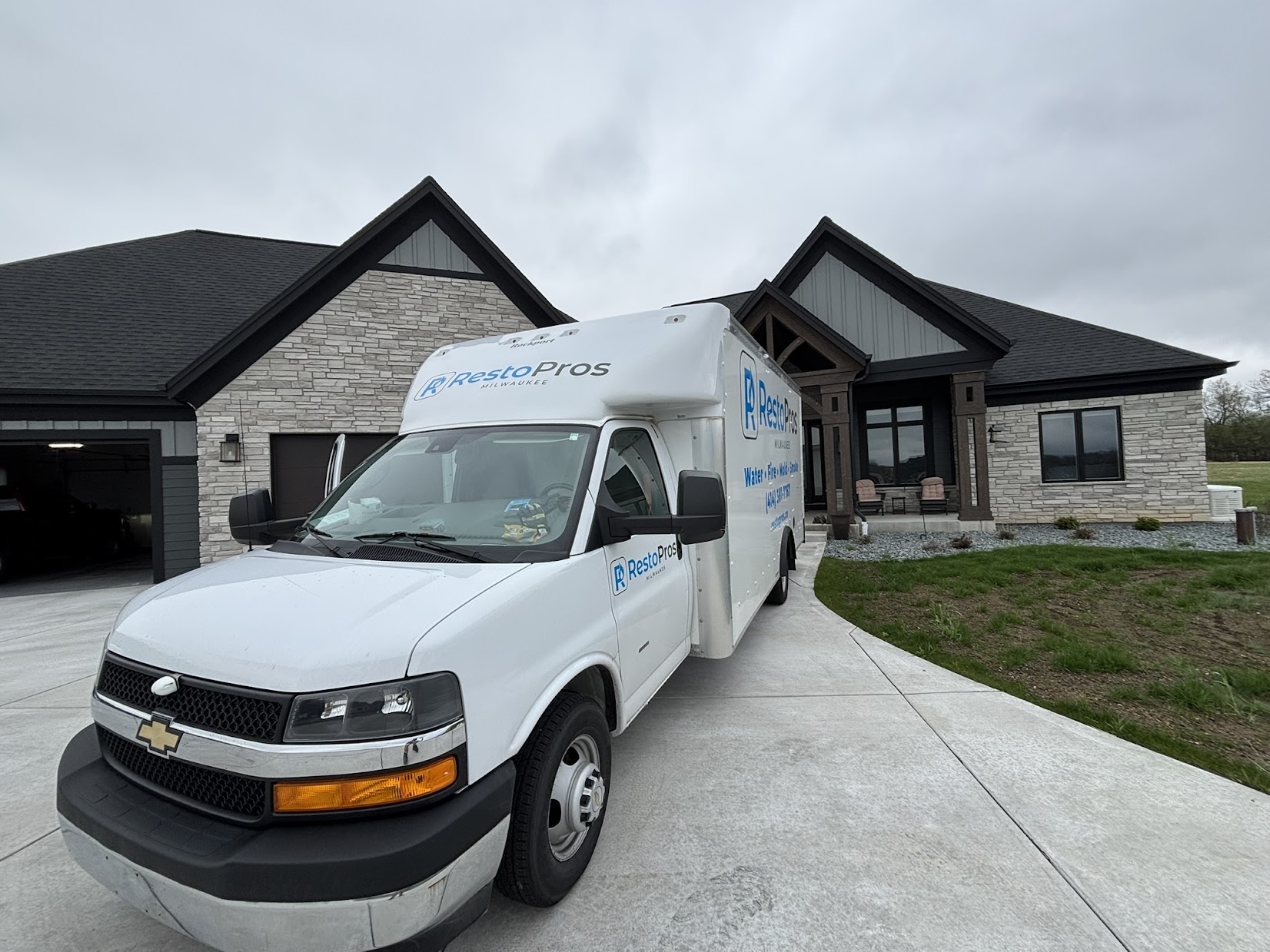 RestoPros truck in front of a house