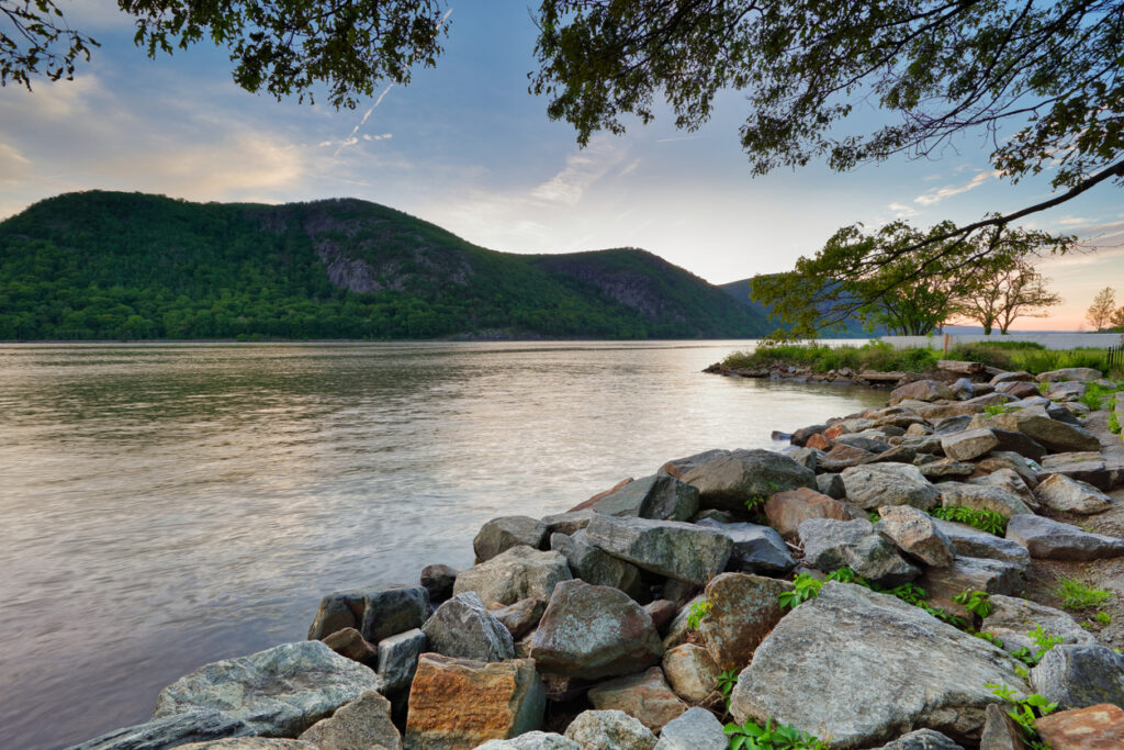 Sun sets behind Storm King Mountain and Hudson River